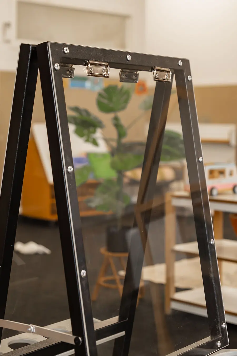 A child painting at an A-frame aluminium easel